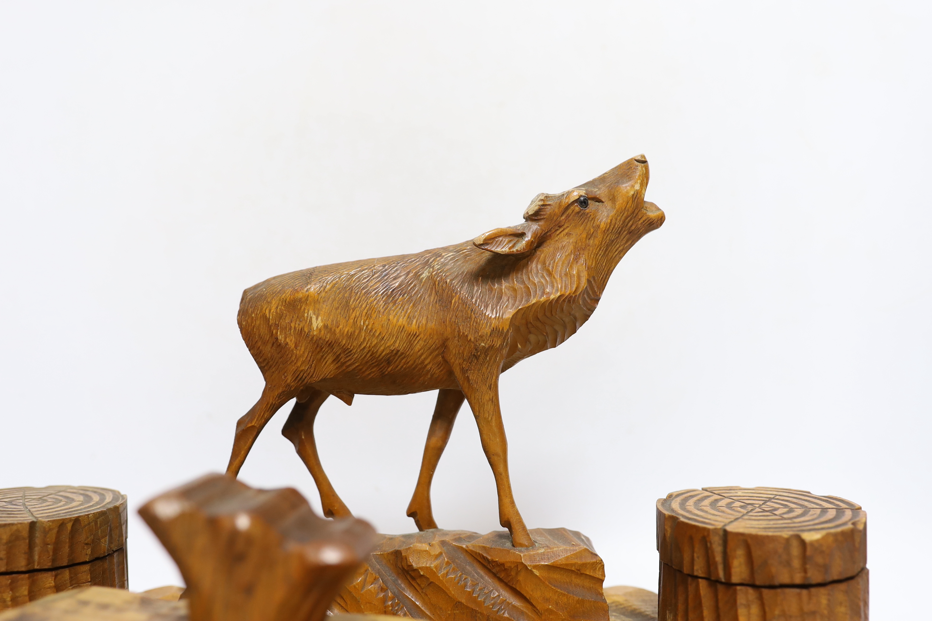 A Swiss carved wood desk set surmounted with a deer, 41cm wide